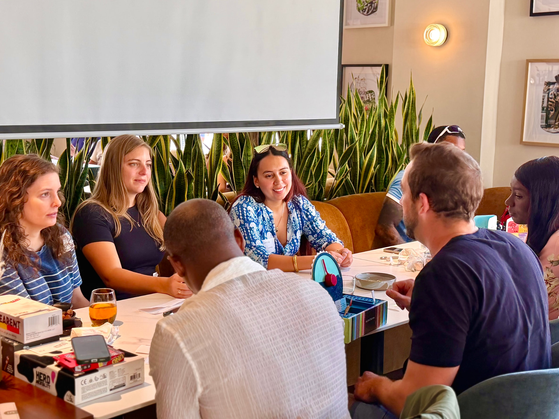 Guests talking around a table of games at a Convive gathering